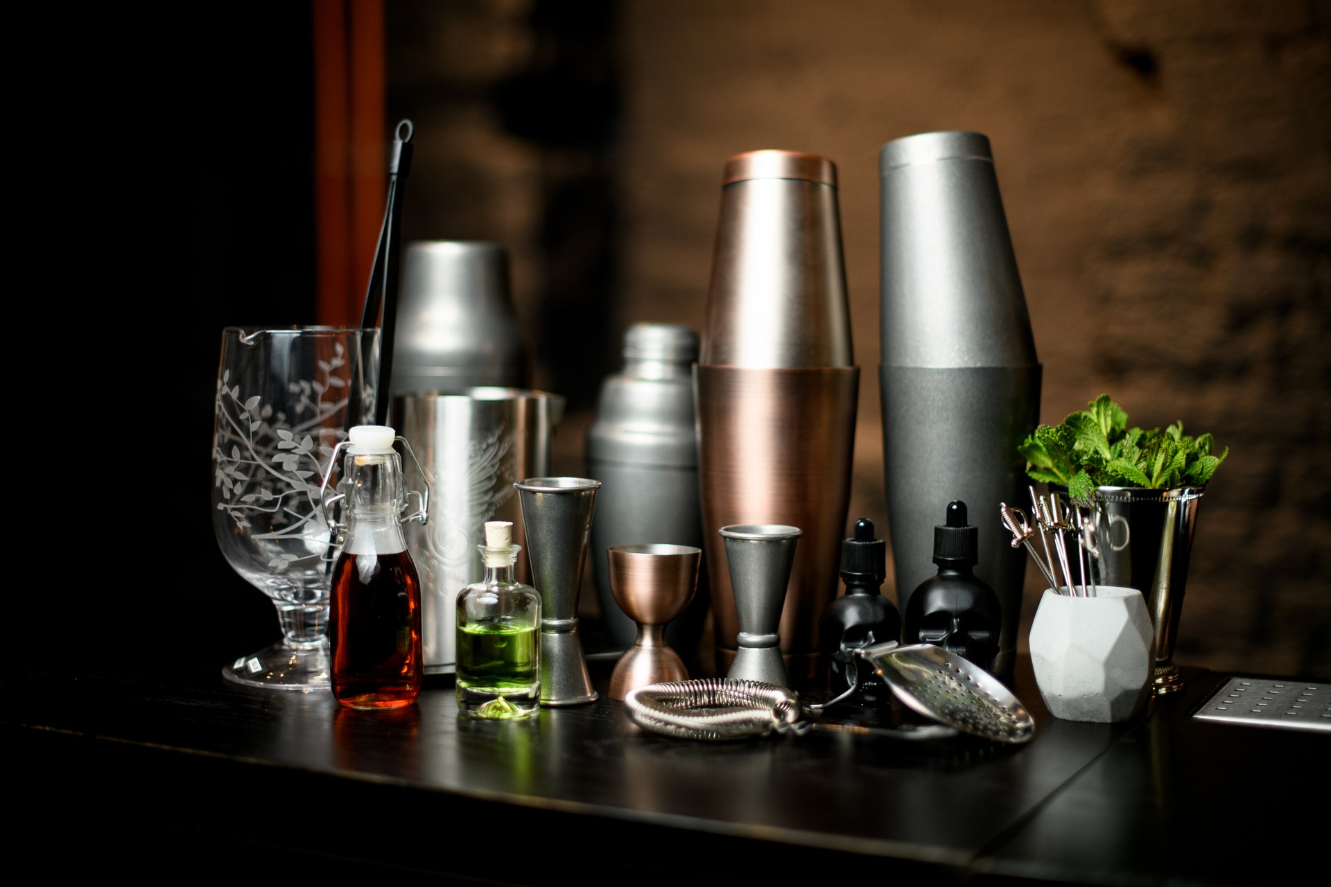 different bar equipment and tools stand on bar counter